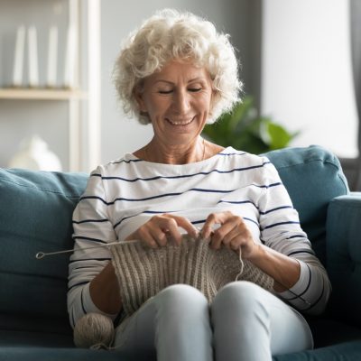 Happy,Mature,60s,Grandmother,Sit,Relax,On,Couch,In,Living